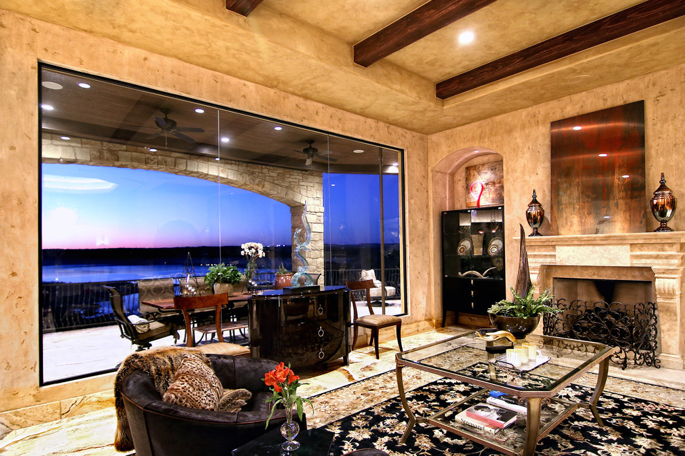 Design ideas for a large mediterranean formal open concept living room in Austin with multi-coloured walls, travertine floors, a standard fireplace and no tv.