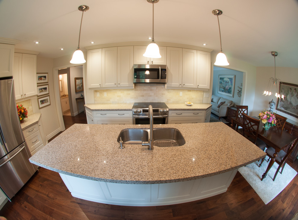 Mid-sized transitional l-shaped eat-in kitchen in Toronto with a double-bowl sink, shaker cabinets, white cabinets, granite benchtops, beige splashback, ceramic splashback, stainless steel appliances, dark hardwood floors and with island.