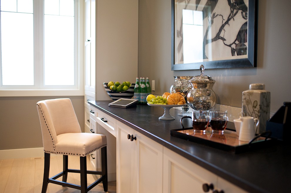 Inspiration for a large transitional galley light wood floor kitchen pantry remodel in Edmonton with shaker cabinets, white cabinets, granite countertops, white backsplash, stone tile backsplash, stainless steel appliances and no island
