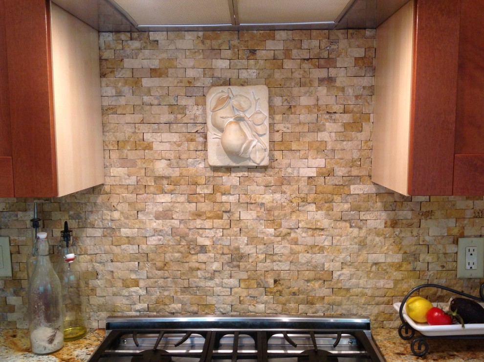 Inspiration for a craftsman kitchen remodel in Boston with recessed-panel cabinets, medium tone wood cabinets, granite countertops, beige backsplash, stone tile backsplash and stainless steel appliances