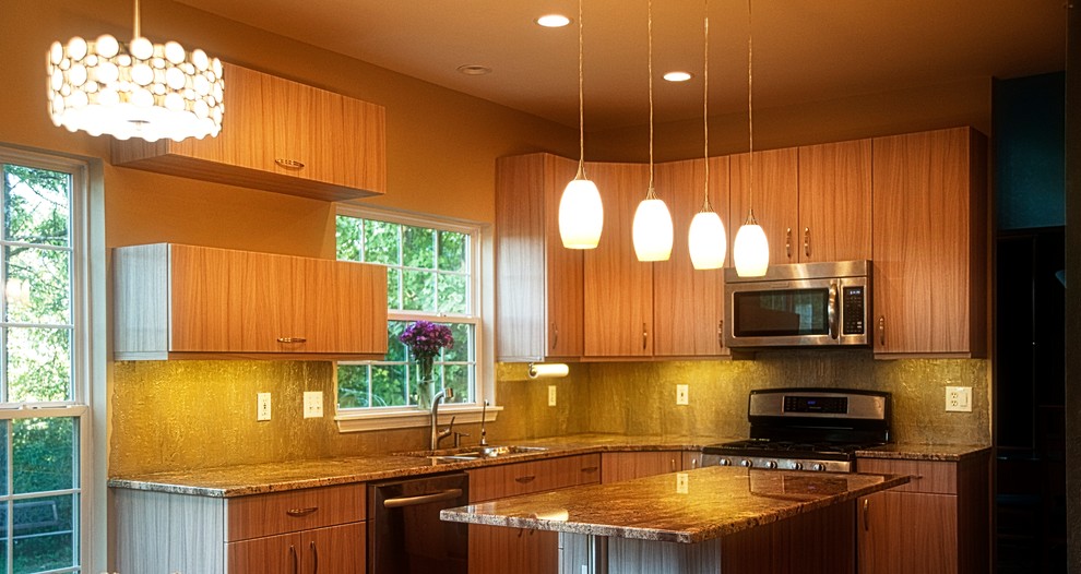 Example of a classic l-shaped eat-in kitchen design in Phoenix with a double-bowl sink, flat-panel cabinets, light wood cabinets, granite countertops, beige backsplash, stainless steel appliances and an island