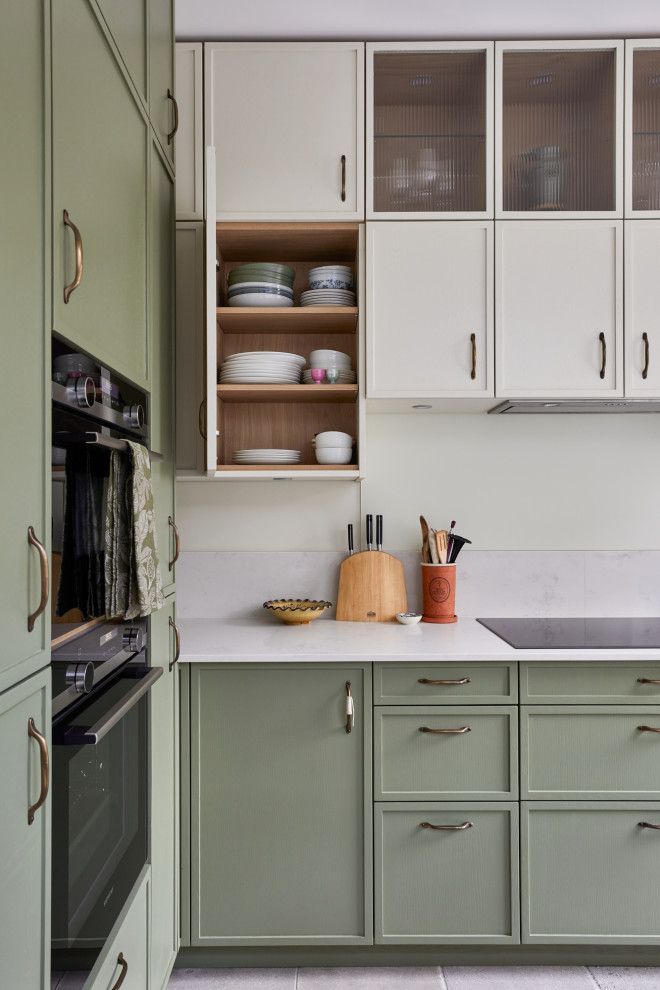 Inspiration for a small classic l-shaped enclosed kitchen in London with recessed-panel cabinets, green cabinets, quartz worktops, a breakfast bar and white worktops.