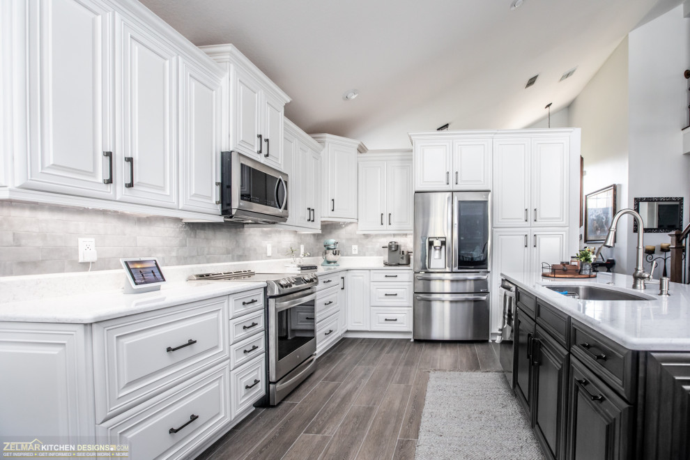 Medium sized classic l-shaped kitchen/diner in Orlando with a submerged sink, raised-panel cabinets, white cabinets, engineered stone countertops, white splashback, ceramic splashback, porcelain flooring, an island, brown floors and white worktops.