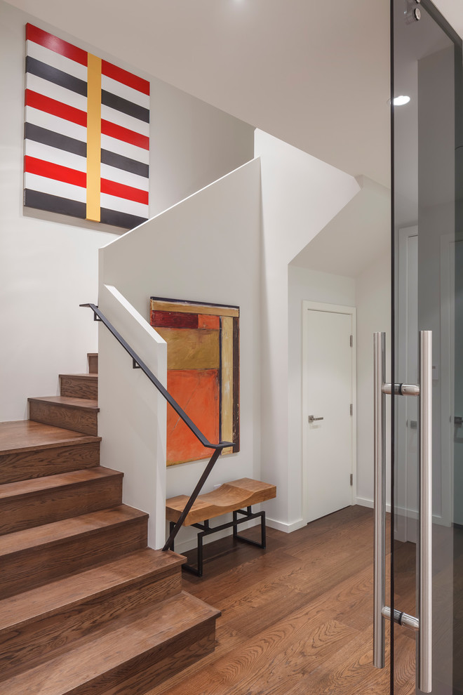 Mid-sized contemporary wood u-shaped staircase in San Francisco with wood risers and metal railing.