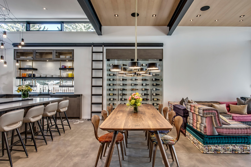 Photo of a large contemporary open plan dining in Calgary with concrete floors, grey walls, no fireplace and grey floor.