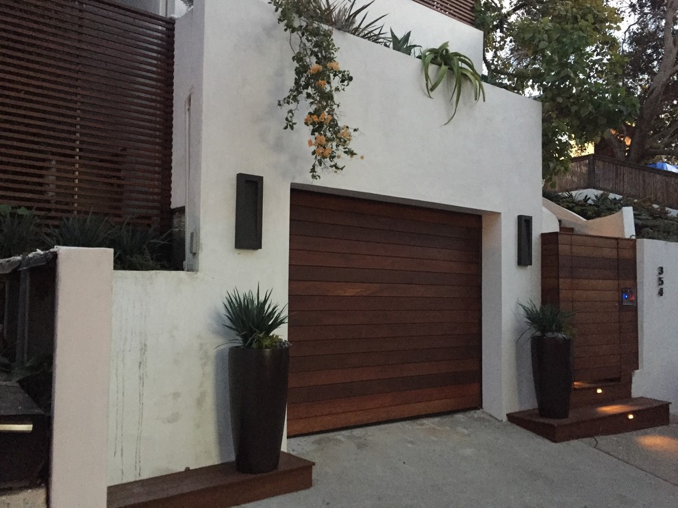 Photo of a mid-sized modern backyard deck in Los Angeles with a container garden and a pergola.