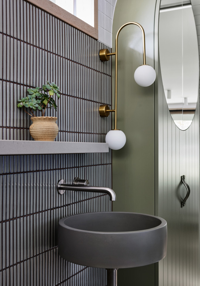 Photo of a mid-sized beach style master bathroom in Melbourne with gray tile, porcelain tile, white walls, porcelain floors, a wall-mount sink, quartzite benchtops, grey floor, an open shower, grey benchtops, a single vanity and a floating vanity.