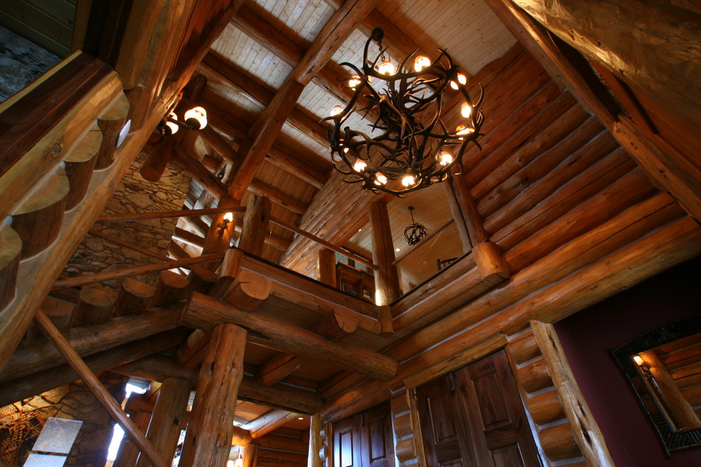 Foyer - huge rustic medium tone wood floor foyer idea in New York