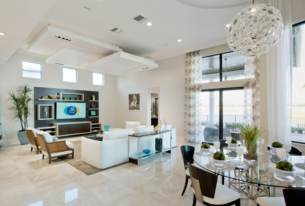 This is an example of a large contemporary open concept family room in Miami with white walls, marble floors and a wall-mounted tv.