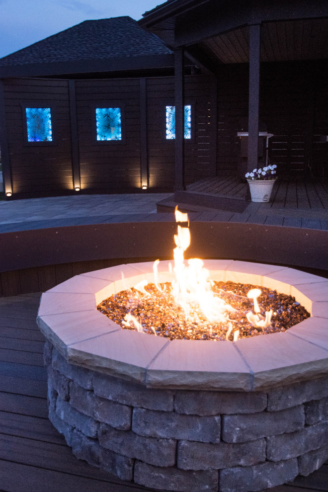 Large transitional backyard deck photo with a fire pit and no cover