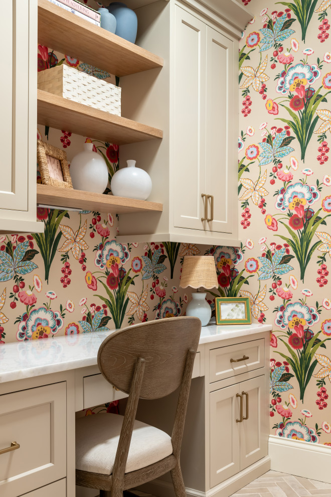 Large transitional built-in desk porcelain tile, wallpaper and beige floor home office photo in St Louis with multicolored walls