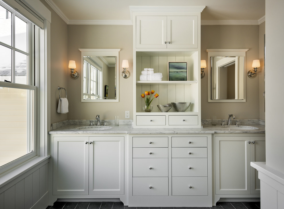 Mid-sized traditional bathroom in Portland Maine with an undermount sink, shaker cabinets, white cabinets, marble benchtops, grey walls and slate floors.