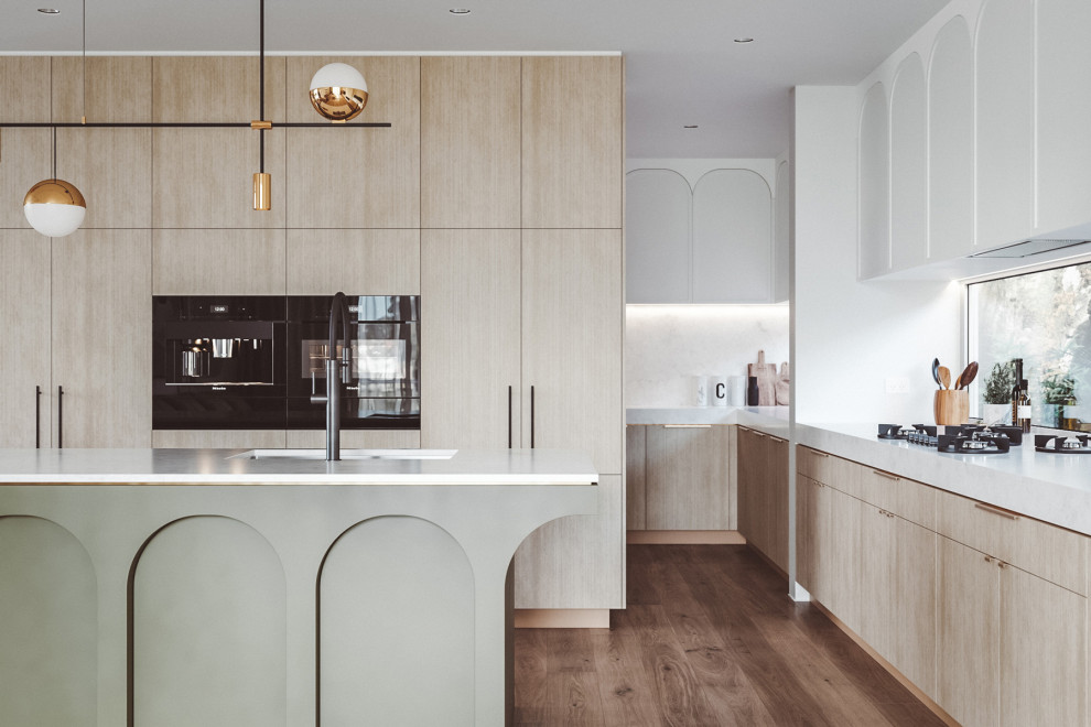Design ideas for a mid-sized contemporary l-shaped open plan kitchen in Sydney with an undermount sink, light wood cabinets, marble benchtops, white splashback, marble splashback, black appliances, medium hardwood floors, with island, brown floor, white benchtop and flat-panel cabinets.