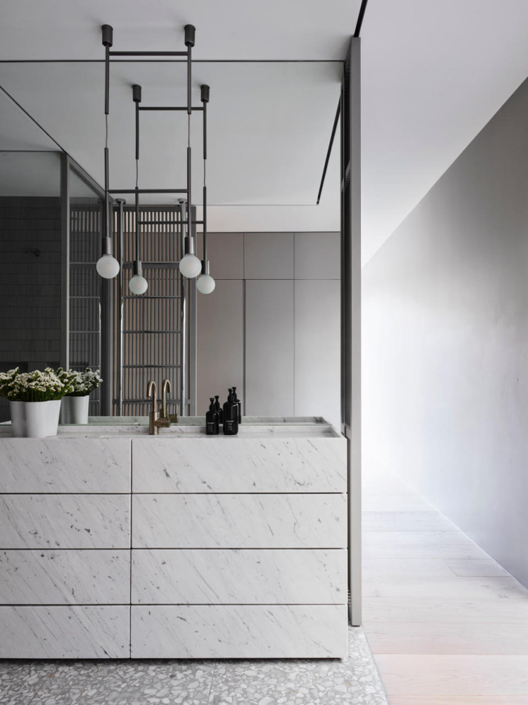 This is an example of a modern bathroom in Sydney with flat-panel cabinets, white cabinets, grey walls, an integrated sink, grey floor, white benchtops, a single vanity and a freestanding vanity.