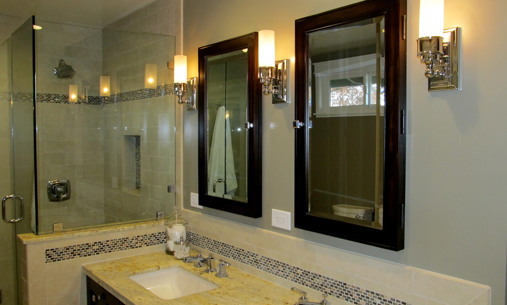 This is an example of an arts and crafts bathroom in San Francisco with an undermount sink, a corner shower, a two-piece toilet, shaker cabinets, dark wood cabinets, granite benchtops, beige tile, porcelain tile, grey walls and porcelain floors.