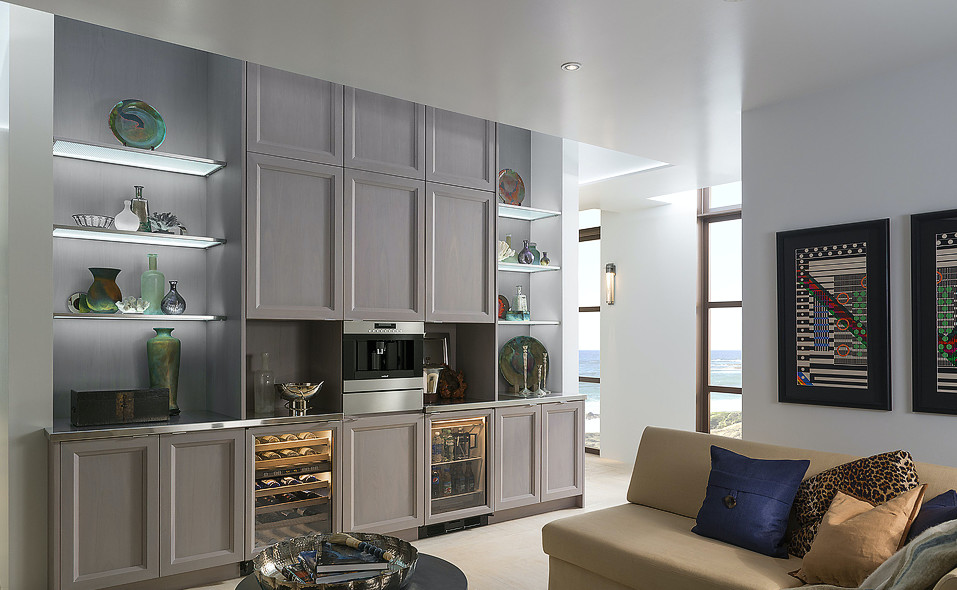 Large contemporary home bar in Miami with recessed-panel cabinets, grey cabinets, stainless steel benchtops and porcelain floors.