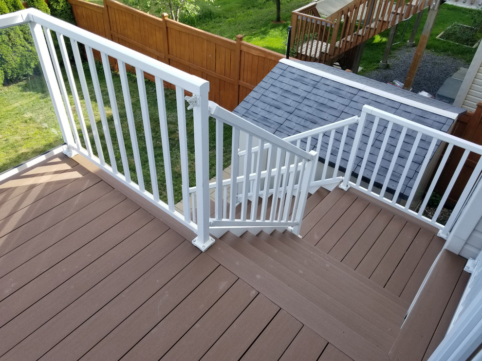 Photo of a large modern backyard deck in Ottawa with with privacy feature and no cover.