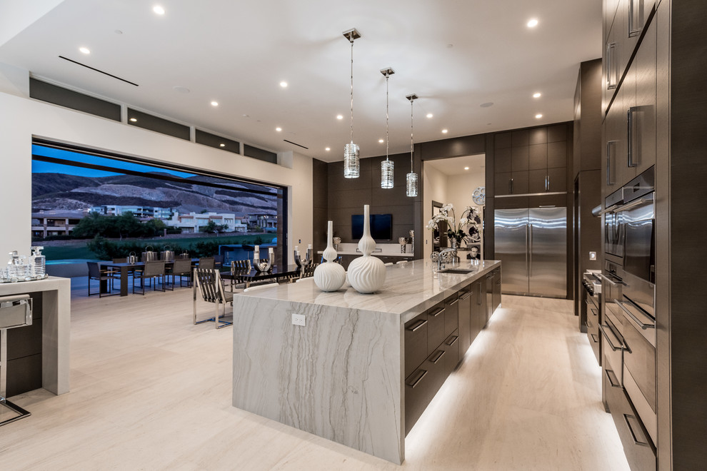 Open concept kitchen - large contemporary l-shaped limestone floor and beige floor open concept kitchen idea in Las Vegas with an undermount sink, flat-panel cabinets, dark wood cabinets, granite countertops, gray backsplash, stone slab backsplash, stainless steel appliances, an island and beige countertops