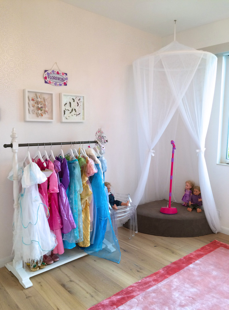 Large beach style kids' bedroom in Miami with white walls, dark hardwood floors and brown floor for kids 4-10 years old and girls.