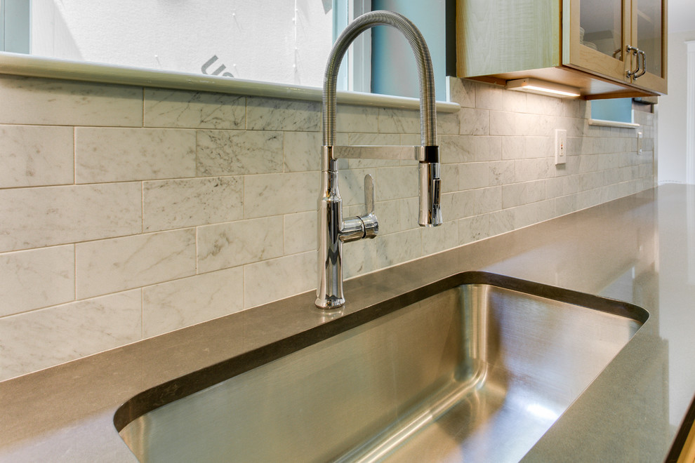 Example of a mid-sized transitional home design design in DC Metro with recessed-panel cabinets, quartz countertops, stainless steel appliances and a peninsula