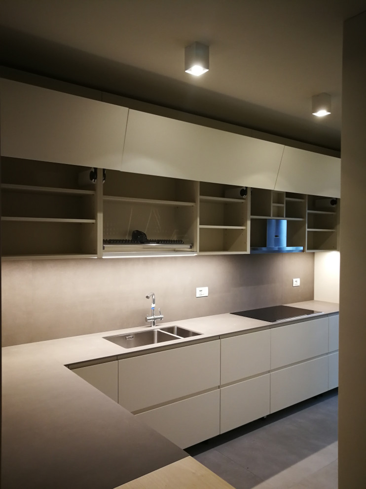 Inspiration for a mid-sized contemporary l-shaped kitchen in Milan with flat-panel cabinets, beige cabinets, quartz benchtops, with island and grey benchtop.