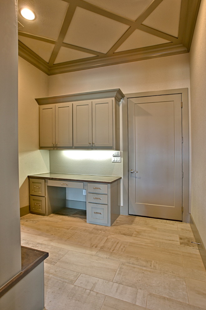 Photo of a small transitional galley dedicated laundry room in Dallas with beige walls, painted wood floors, an undermount sink, shaker cabinets, grey cabinets, granite benchtops and a side-by-side washer and dryer.