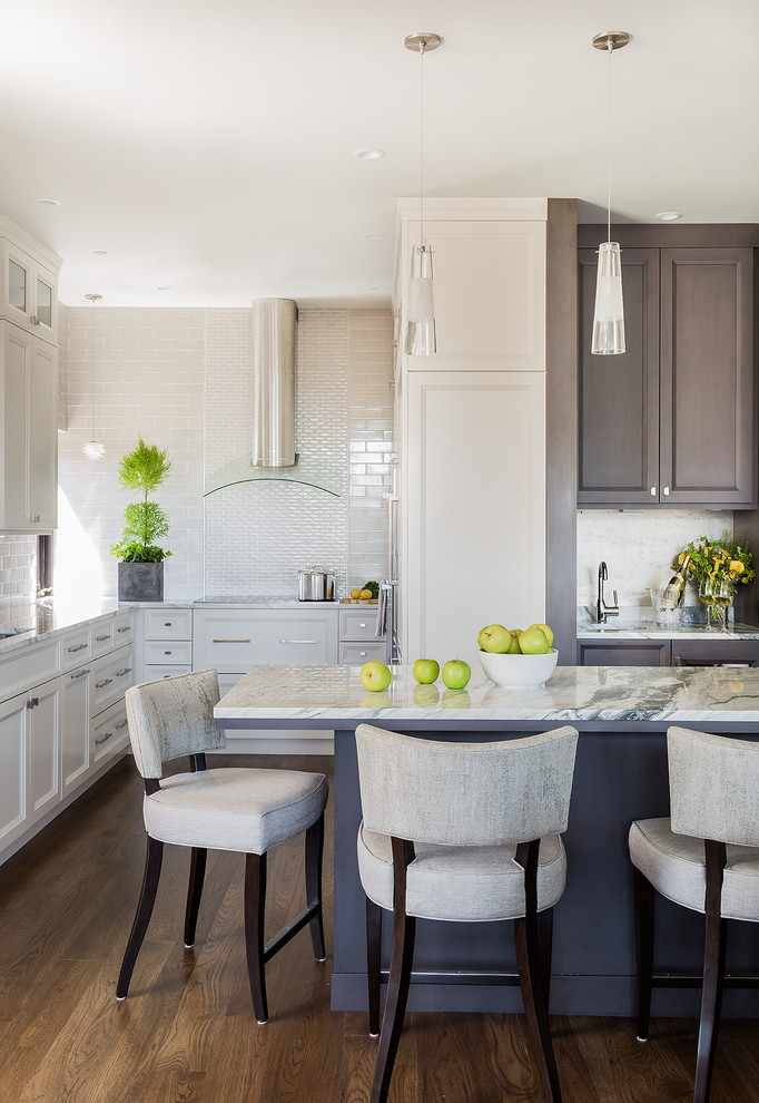 Example of a transitional dark wood floor kitchen design in Boston with recessed-panel cabinets, beige cabinets, beige backsplash, subway tile backsplash and an island