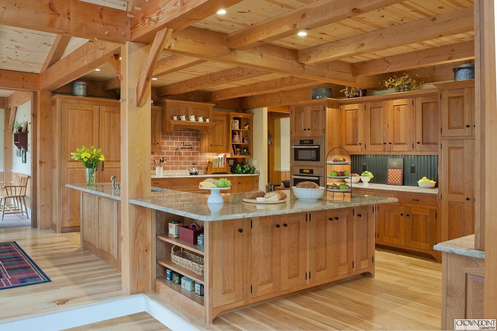 Kitchen - large rustic u-shaped kitchen idea in DC Metro with raised-panel cabinets and an island
