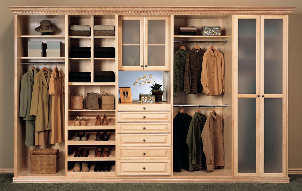 Photo of a mid-sized contemporary gender-neutral built-in wardrobe in Los Angeles with raised-panel cabinets, light wood cabinets and carpet.