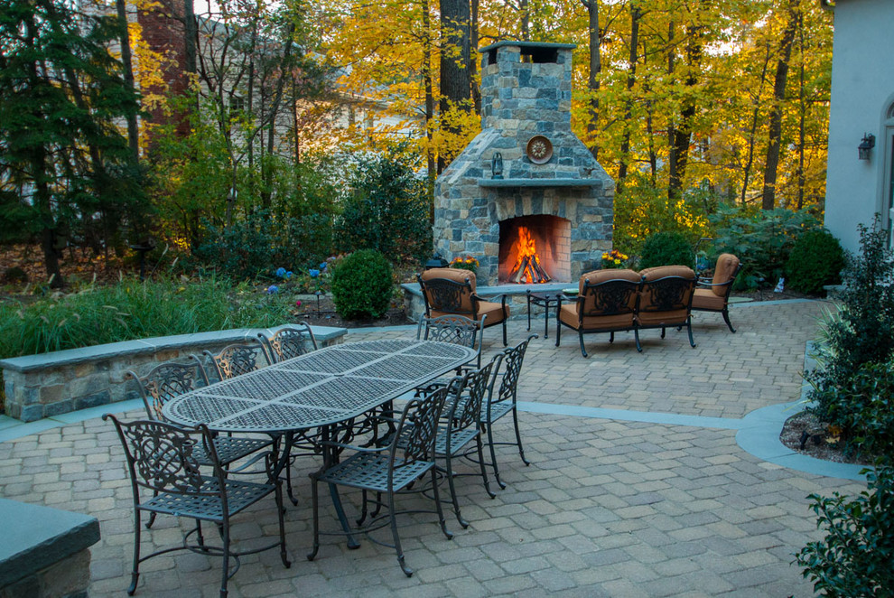 Inspiration for a traditional backyard patio in New York with a fire feature and no cover.