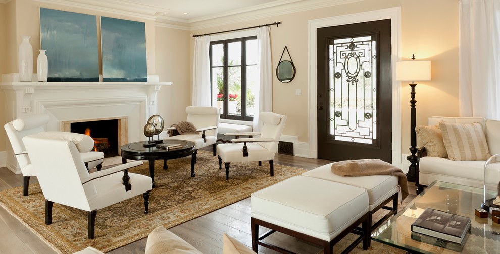 Inspiration for a mediterranean living room in Orange County with beige walls, a standard fireplace and no tv.