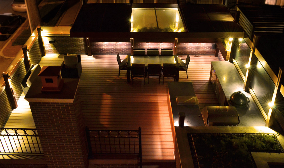 This is an example of a large contemporary rooftop deck in Chicago with a fire feature and a pergola.
