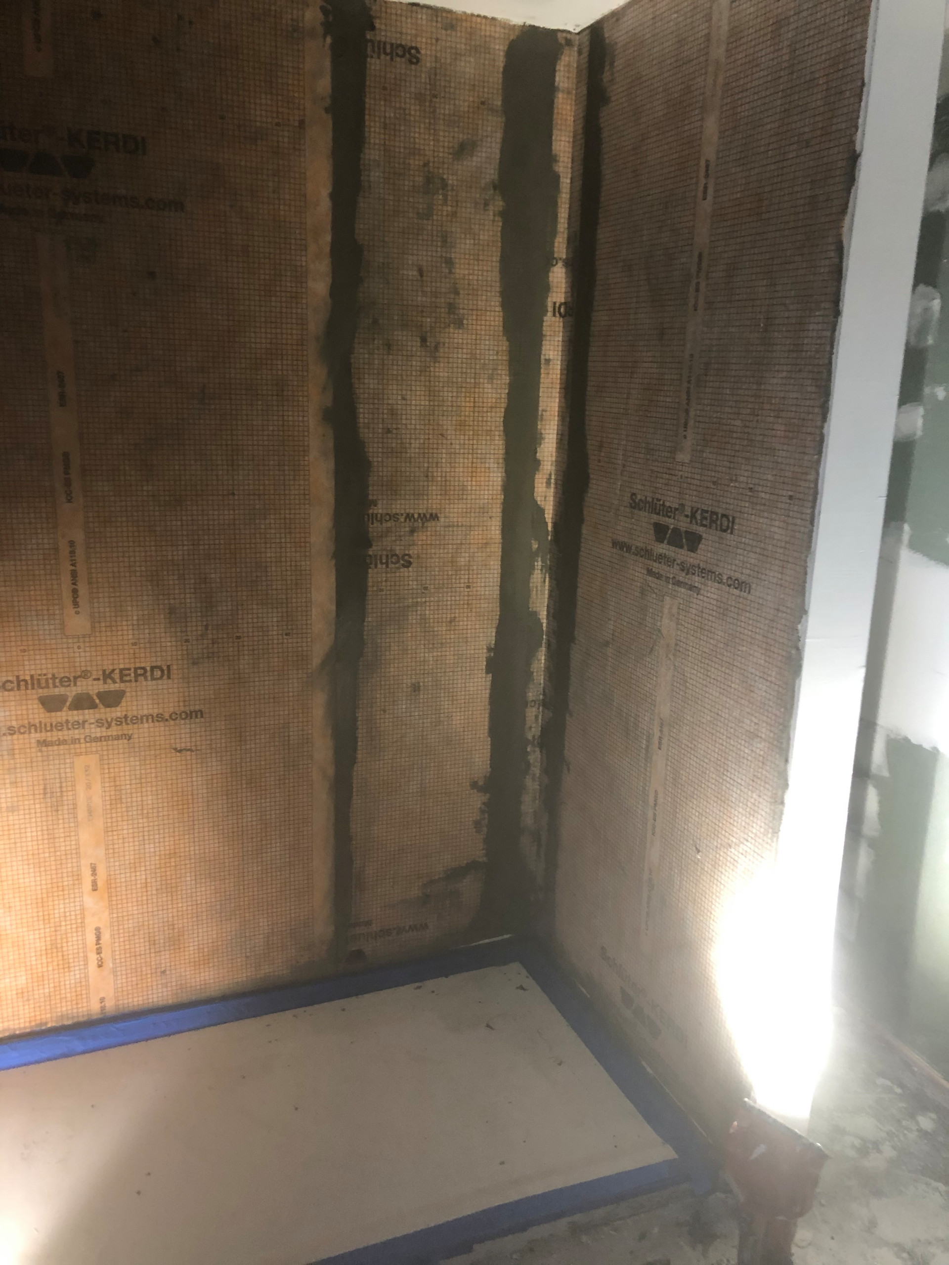 Tile install process including under tile waterproofing