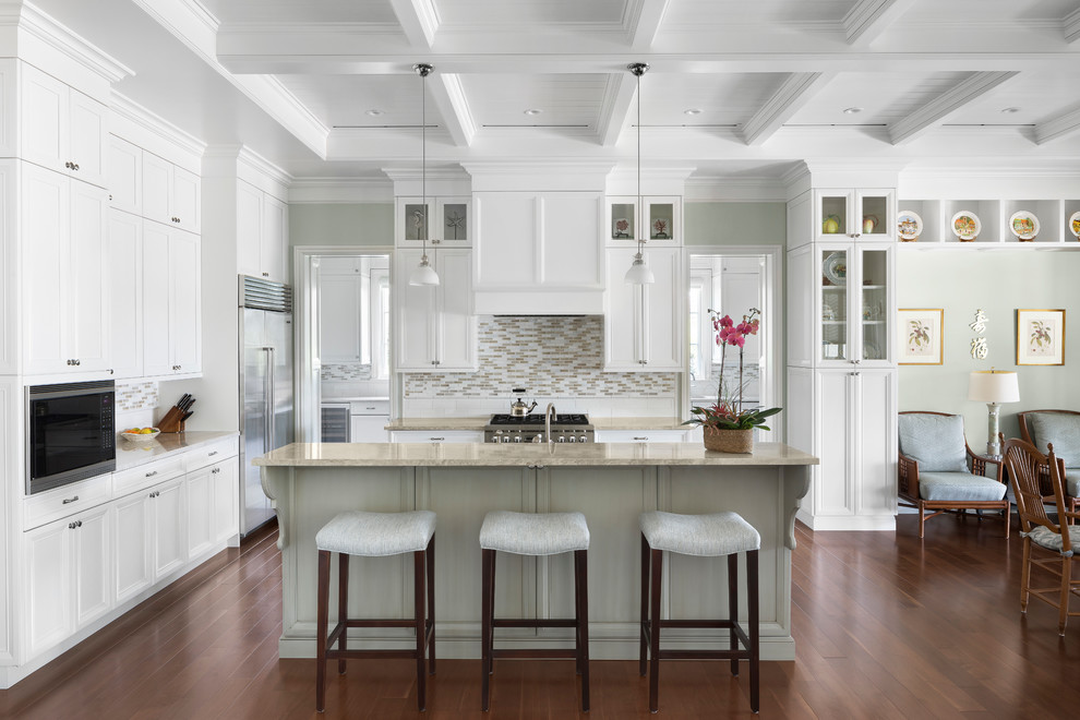 Inspiration for a beach style l-shaped open plan kitchen in Miami with shaker cabinets, white cabinets, multi-coloured splashback, dark hardwood floors, with island, brown floor, beige benchtop and matchstick tile splashback.