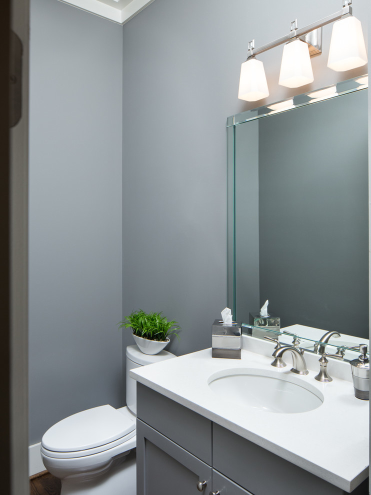 This is an example of a small traditional powder room in Birmingham with recessed-panel cabinets, grey cabinets, a two-piece toilet, grey walls, an undermount sink and engineered quartz benchtops.
