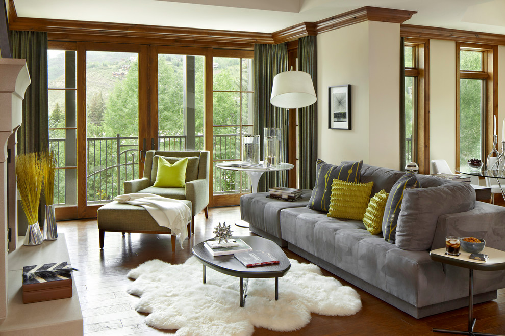 This is an example of a country open concept living room in Denver with beige walls.