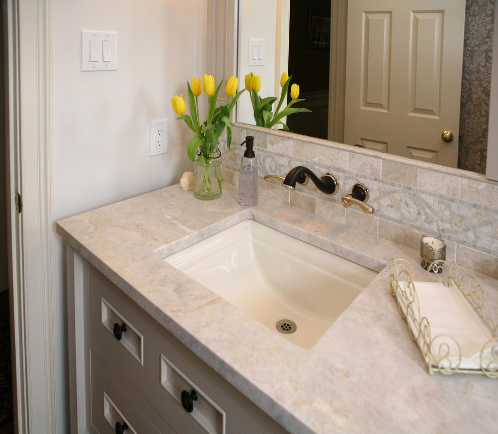 This is an example of a mid-sized transitional 3/4 bathroom in Philadelphia with furniture-like cabinets, white cabinets, a two-piece toilet, beige walls, plywood floors, an undermount sink and marble benchtops.