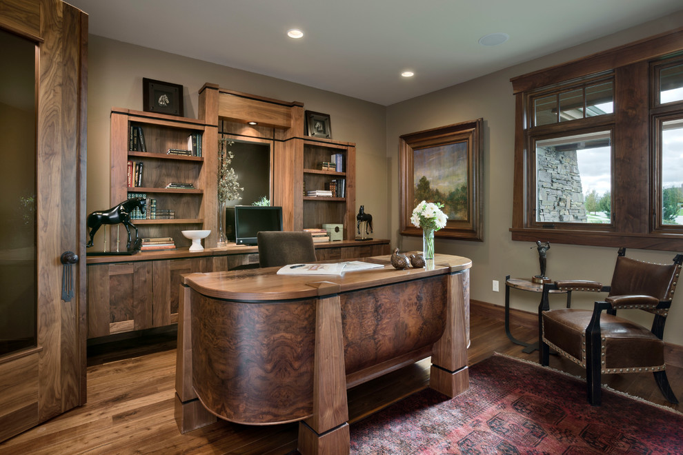 Country home office in Other with dark hardwood floors and a freestanding desk.