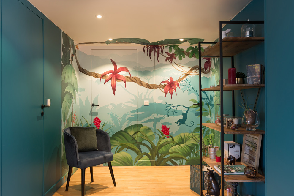 This is an example of a mid-sized tropical hallway in Paris with blue walls and light hardwood floors.