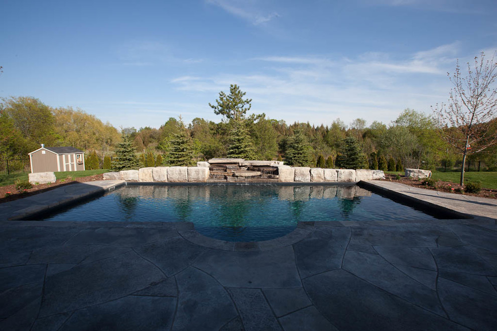 Mid-sized elegant backyard concrete and rectangular lap pool fountain photo