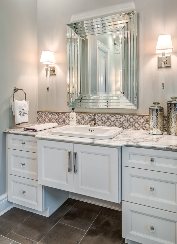 Inspiration for an expansive transitional master bathroom in Cincinnati with furniture-like cabinets, white cabinets, a corner shower, subway tile, grey walls, porcelain floors, a drop-in sink, marble benchtops, brown floor, a hinged shower door and multi-coloured benchtops.