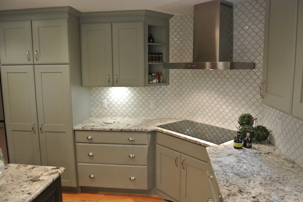 Eat-in kitchen - large transitional l-shaped light wood floor eat-in kitchen idea in Boston with a farmhouse sink, shaker cabinets, gray cabinets, granite countertops, white backsplash, ceramic backsplash, stainless steel appliances, an island and gray countertops