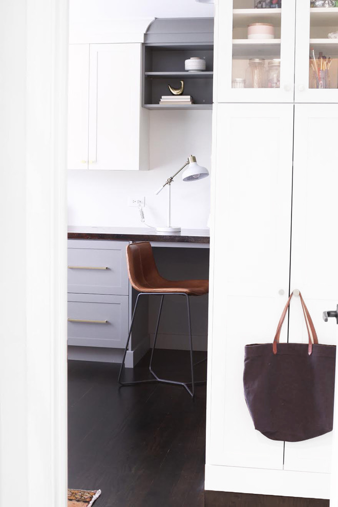 Inspiration for a small transitional built-in desk dark wood floor and brown floor home office remodel in Chicago