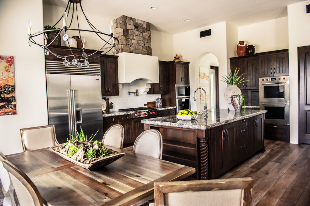 Transitional beige floor eat-in kitchen photo in Phoenix with brown cabinets, stainless steel appliances and an island