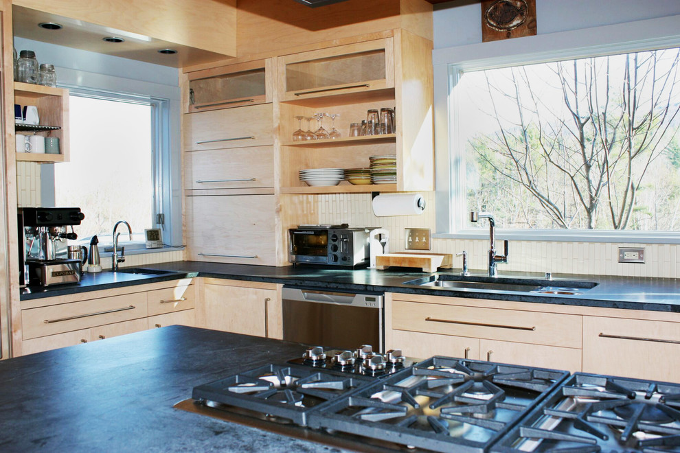 Mid-sized modern l-shaped kitchen in Burlington with flat-panel cabinets, light wood cabinets, soapstone benchtops, with island, a single-bowl sink, white splashback and ceramic splashback.