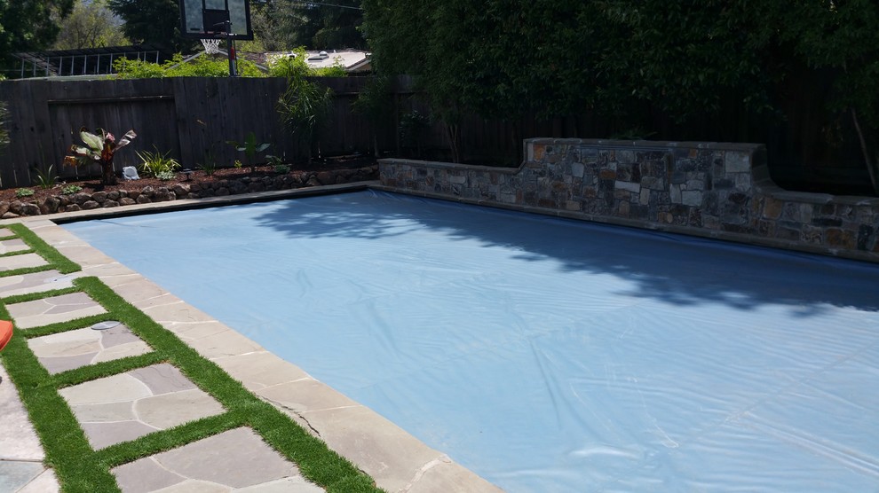 Example of a mid-sized transitional backyard stone and rectangular lap pool fountain design in San Francisco