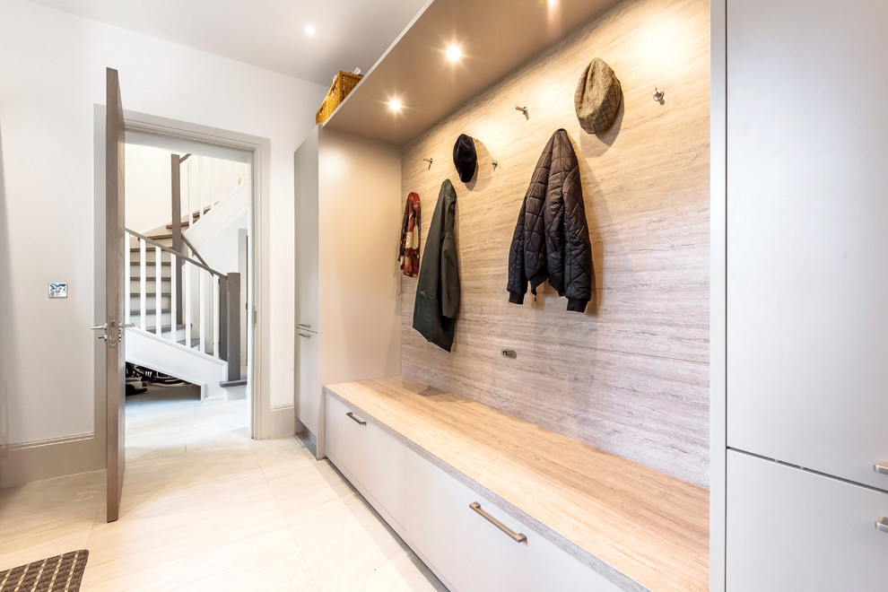 Design ideas for a transitional mudroom in Berkshire with white walls and white floor.