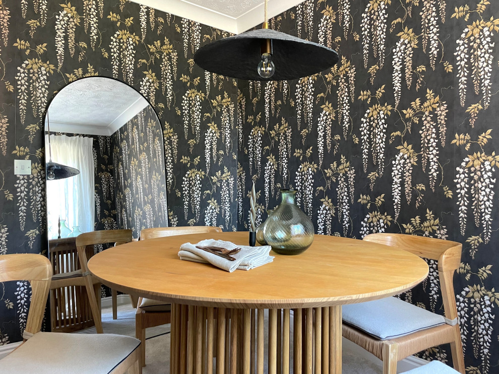 This is an example of a small contemporary enclosed dining room in West Midlands with black walls, carpet, grey floors, wallpapered walls and a feature wall.