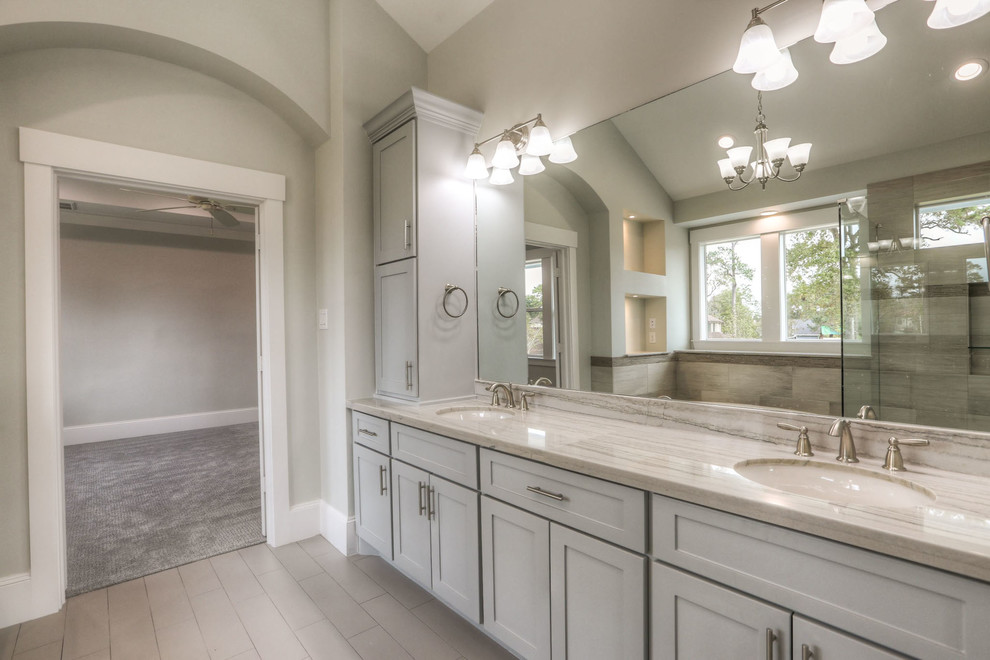 Inspiration for a mid-sized transitional white tile and ceramic tile ceramic tile and gray floor drop-in bathtub remodel in Houston with shaker cabinets, white cabinets, a two-piece toilet, white walls, an undermount sink, granite countertops and a hinged shower door