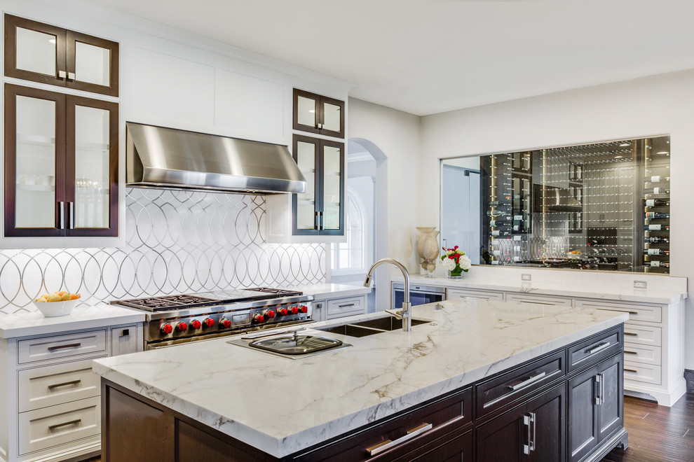 This is an example of a transitional kitchen in Dallas with marble benchtops, porcelain splashback, stainless steel appliances, dark hardwood floors, a double-bowl sink, beaded inset cabinets, white cabinets and metallic splashback.
